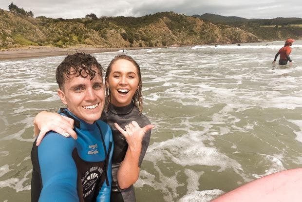Couple learning to surf at Raglan in New Zealand