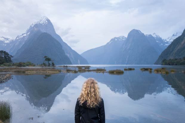 Woman looking out at Milford Sound