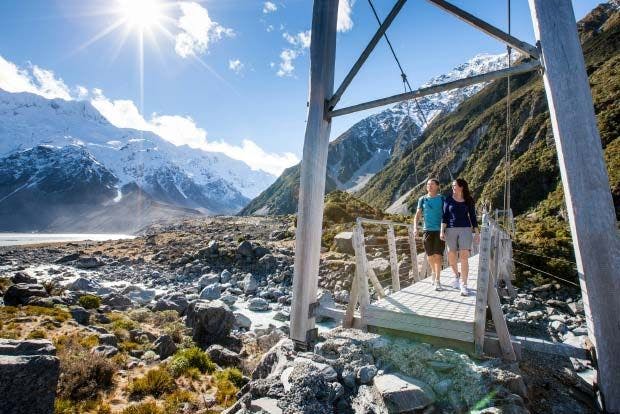 Couple walking Hooker Valley in New Zealand