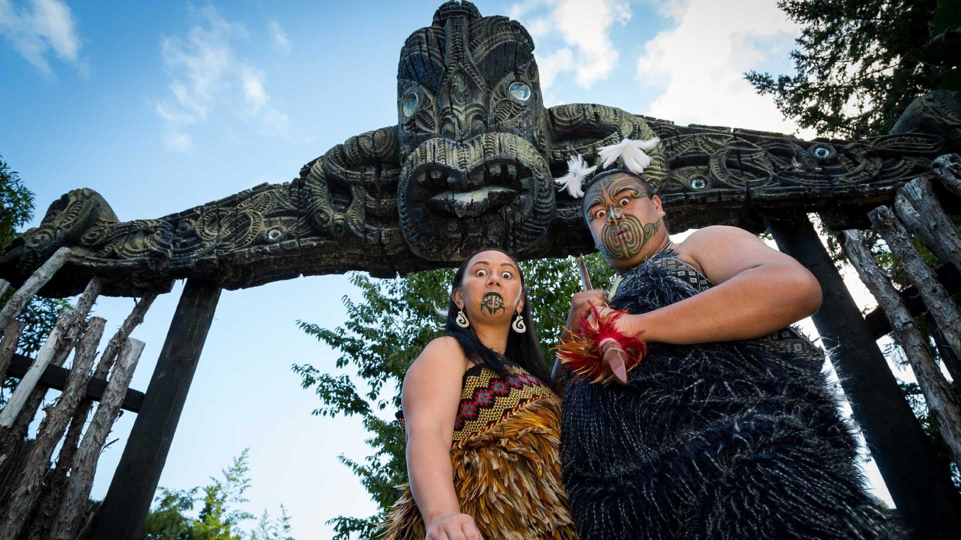 Maori man and woman performing a challenge 