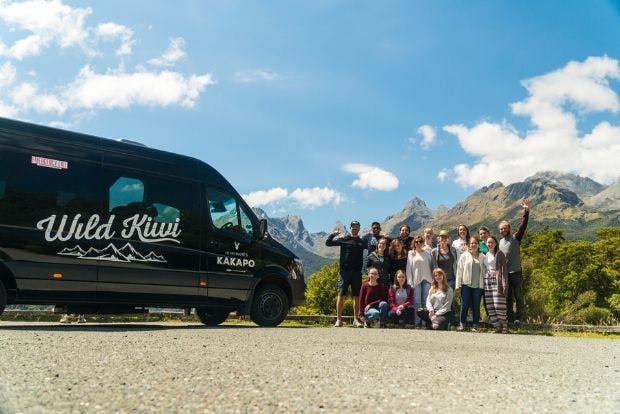 Guests standing outside Wild Kiwi vehicle