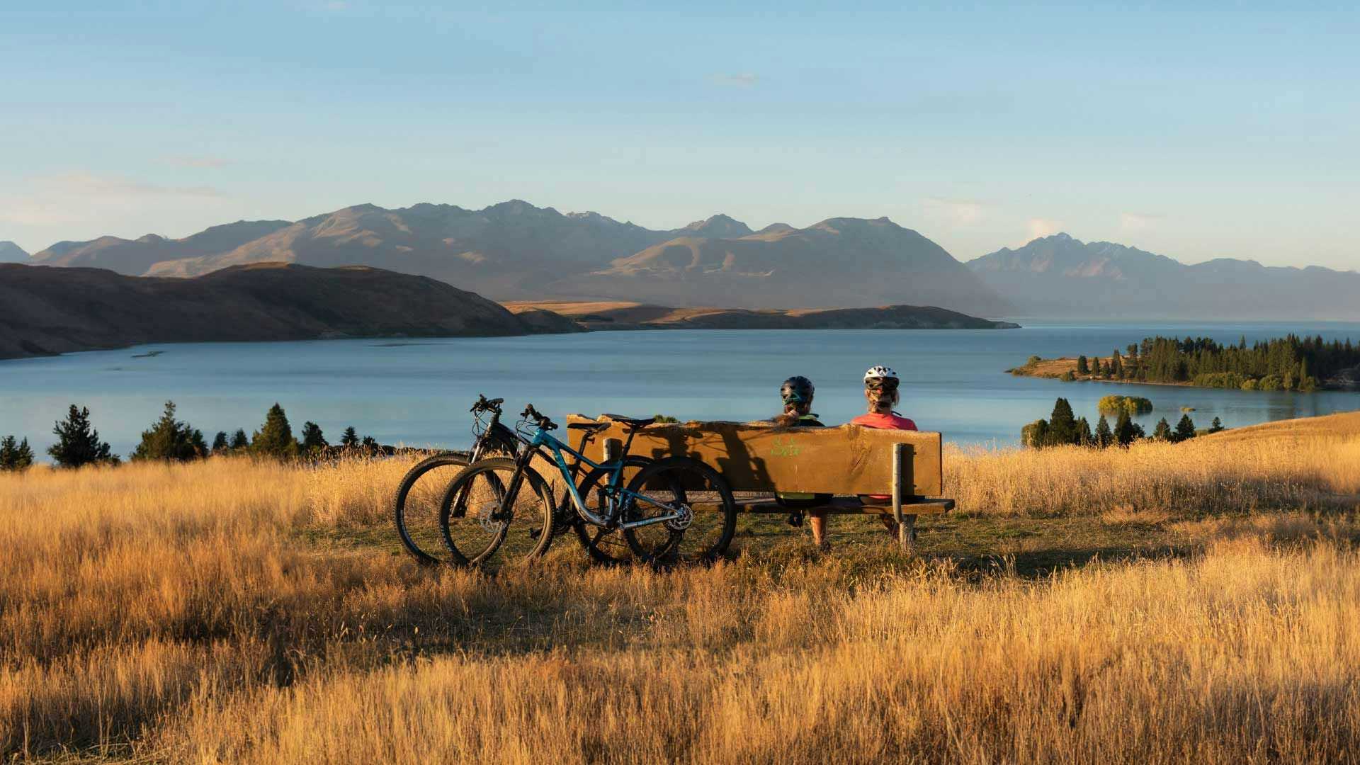 Two cyclists admire the view at Lake Tekapo