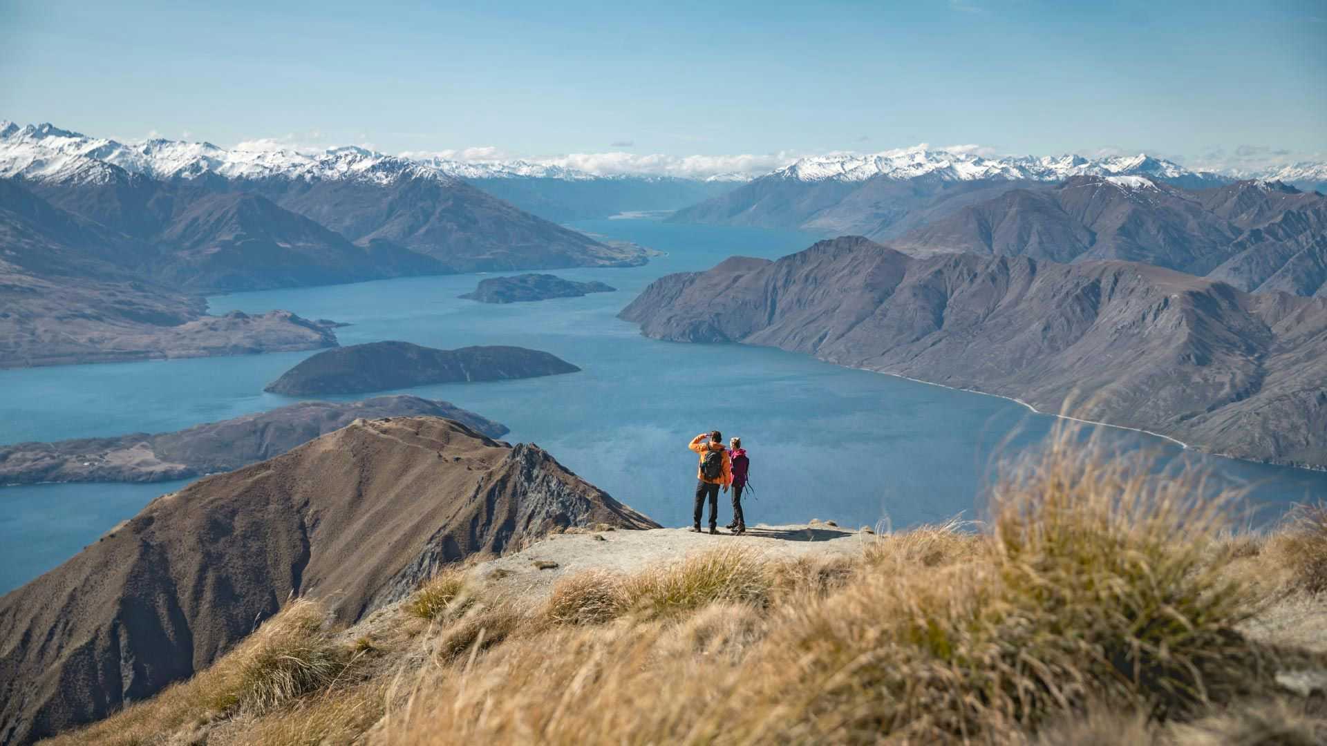 Two people on the top of Roys Peak in New Zealand