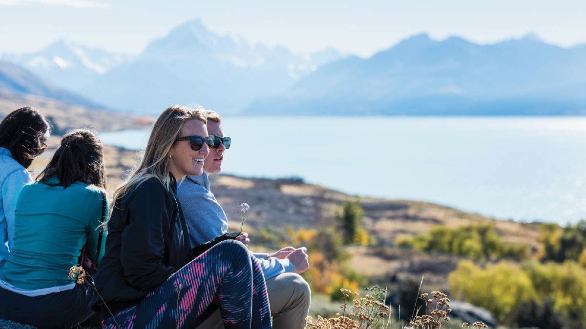 Couple admire the views over Lake Pukaki in New Zealand
