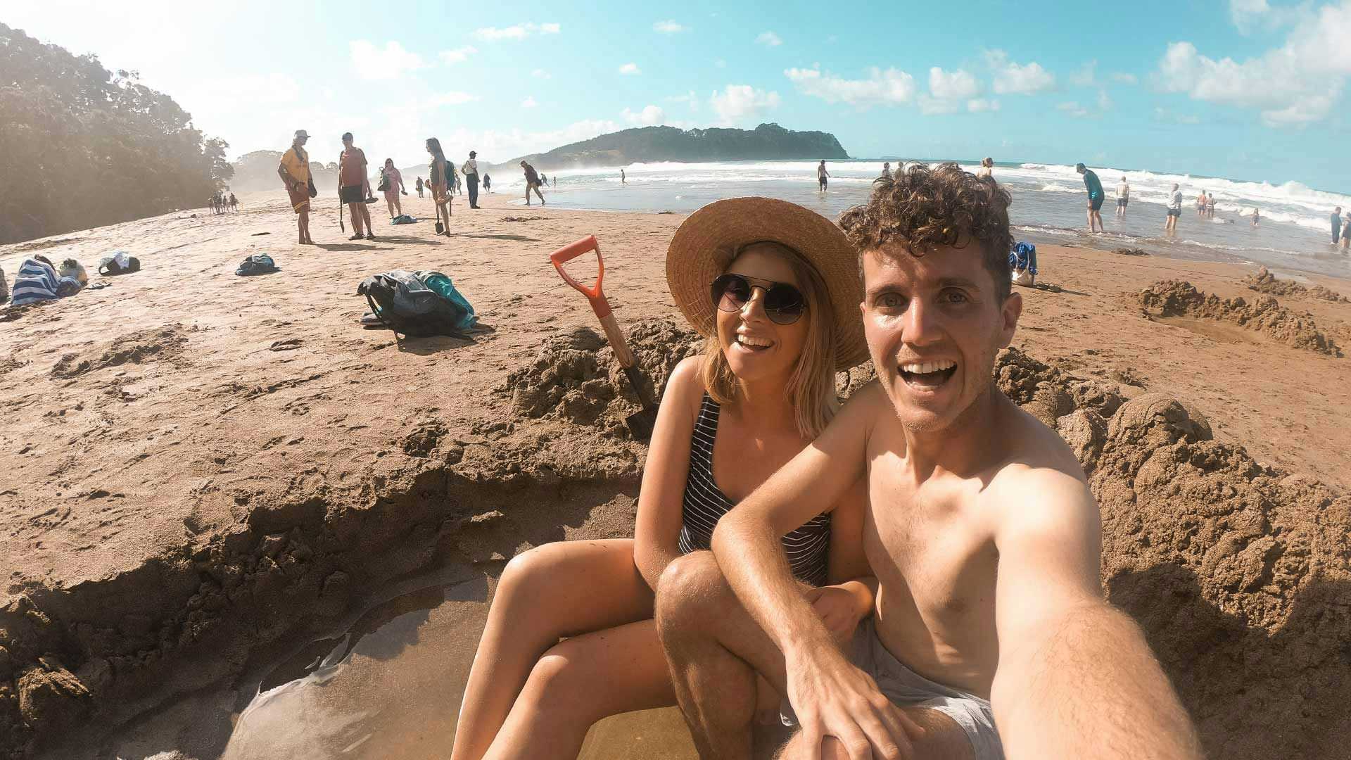 Couple in a hot pool at Hot Water Beach in New Zealand