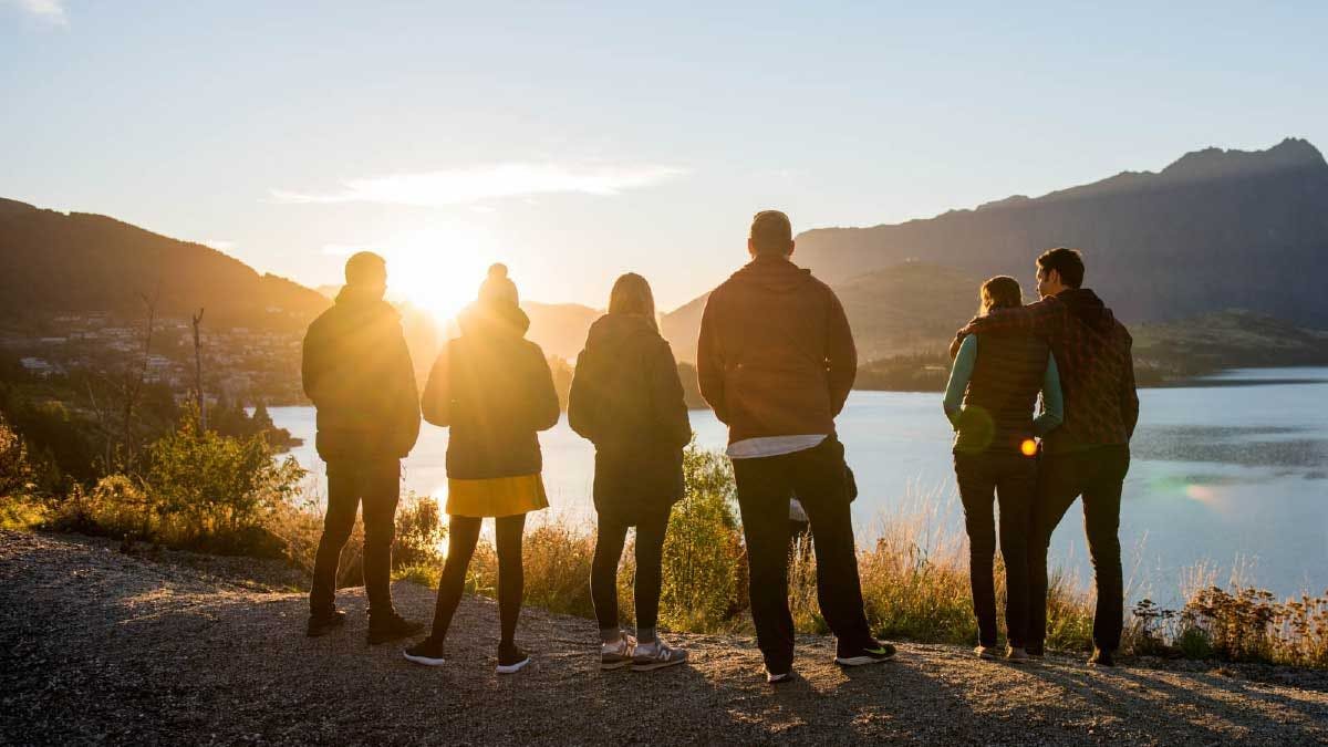 Group of Wild Kiwi guests watching the sunrise over Queenstown