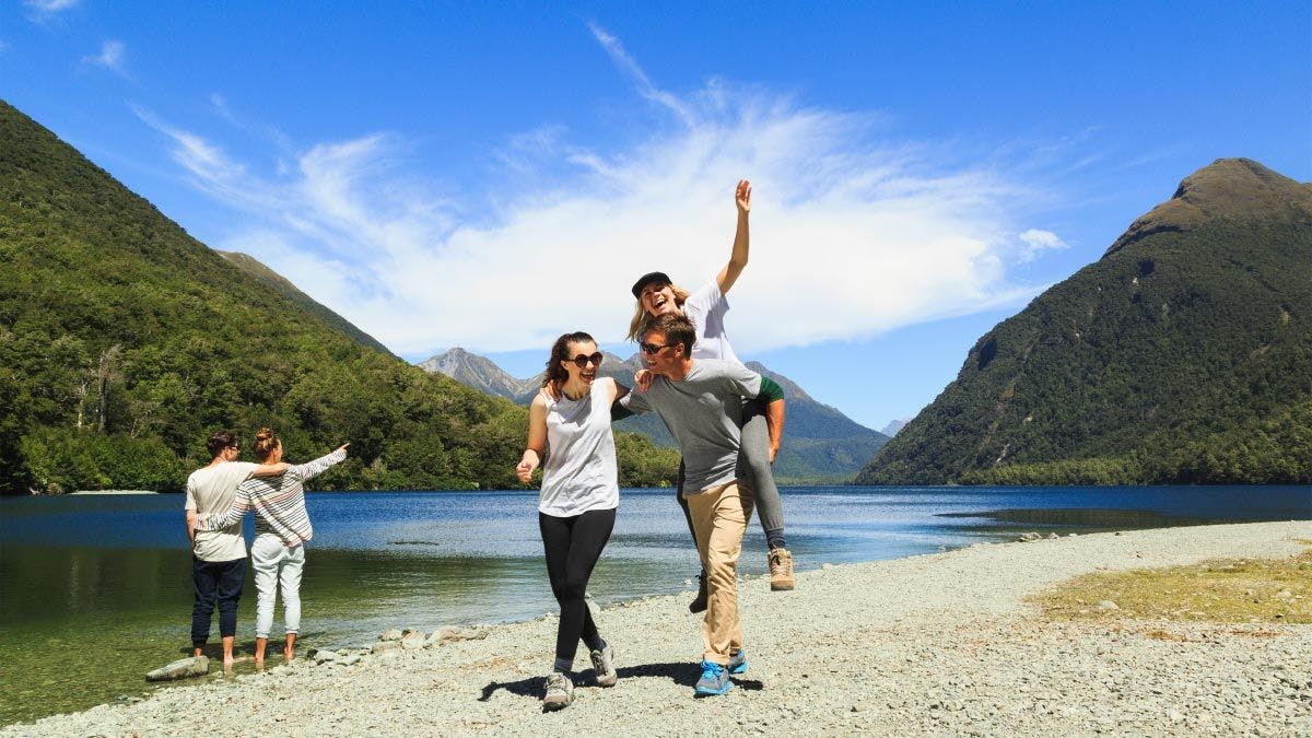 Group of people having fun next to a river in New Zealand