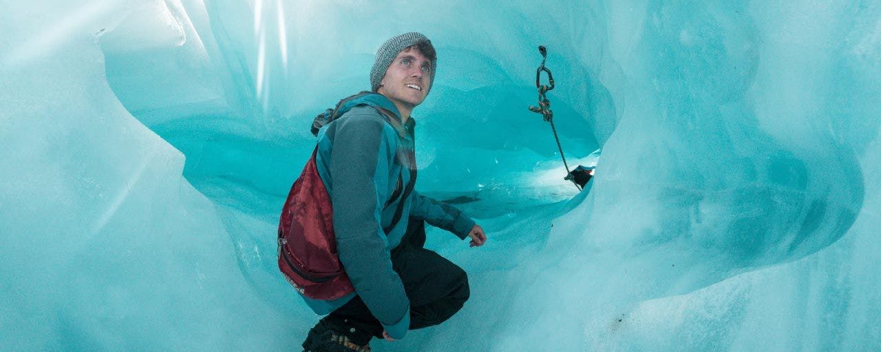 Man in an ice cave on Franz Josef Glacier