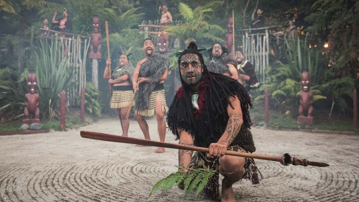 Māori man greeting visitors to the Tamaki Māori Village