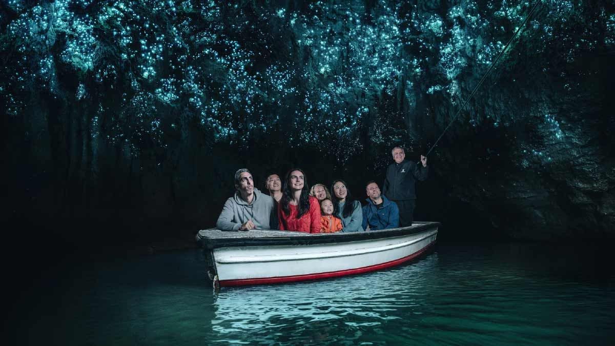 Group of people on a boat in the Waitomo glowworm caves