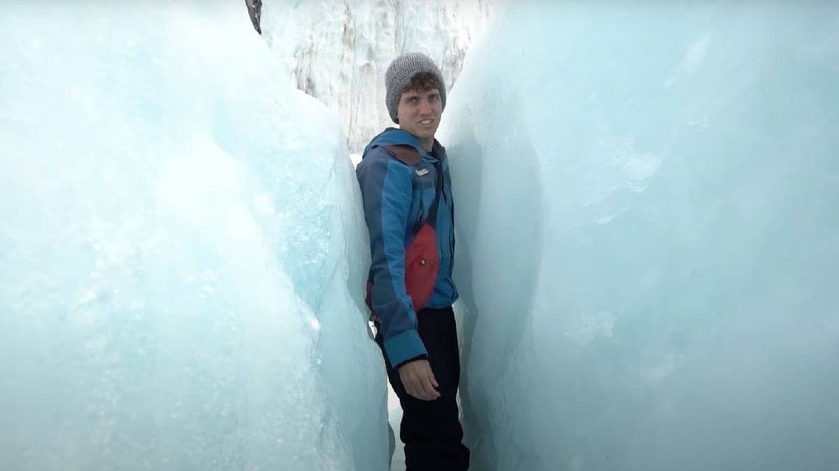 Man squeezing between the ice on Franz Josef Glacier