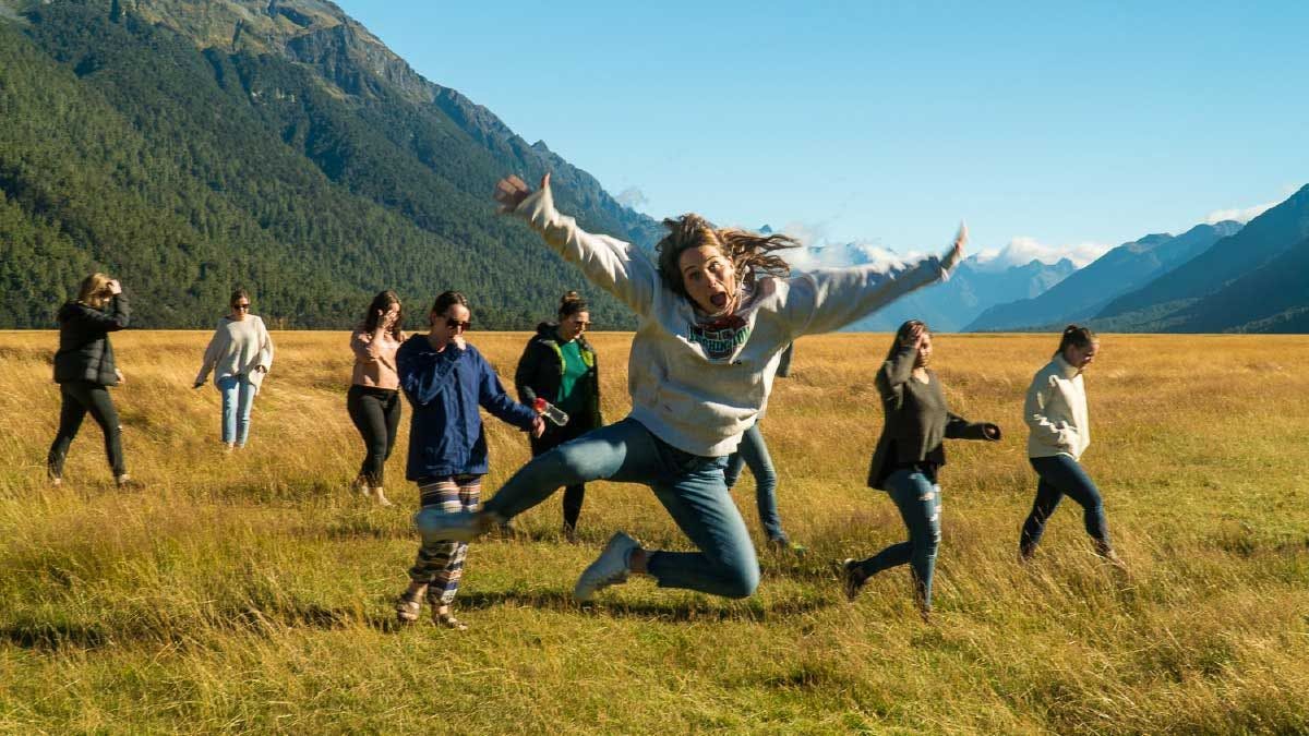 Woman jumping for joy in Fiordland National Park