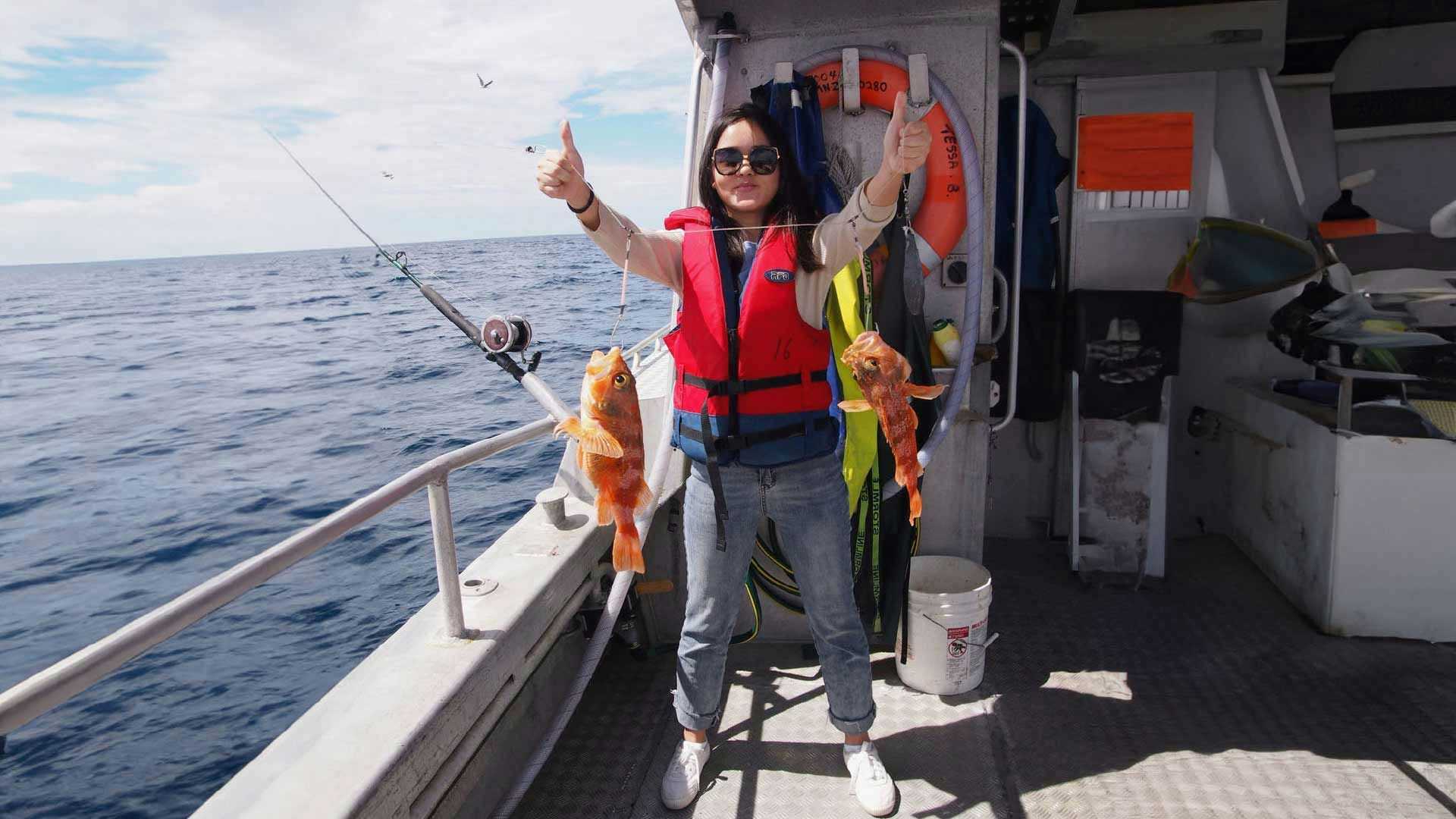 Woman holding up a couple of fish