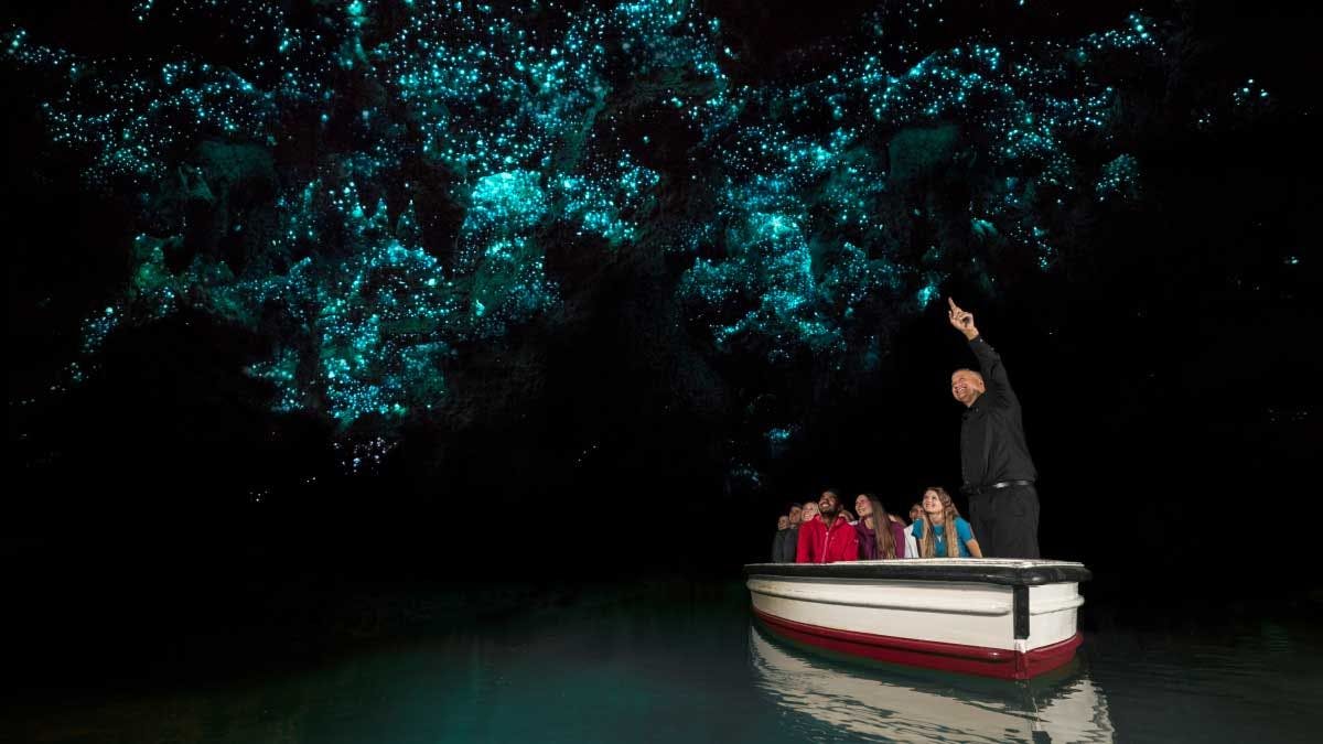 Group of people on a boat tour of Waitomo glowworm caves