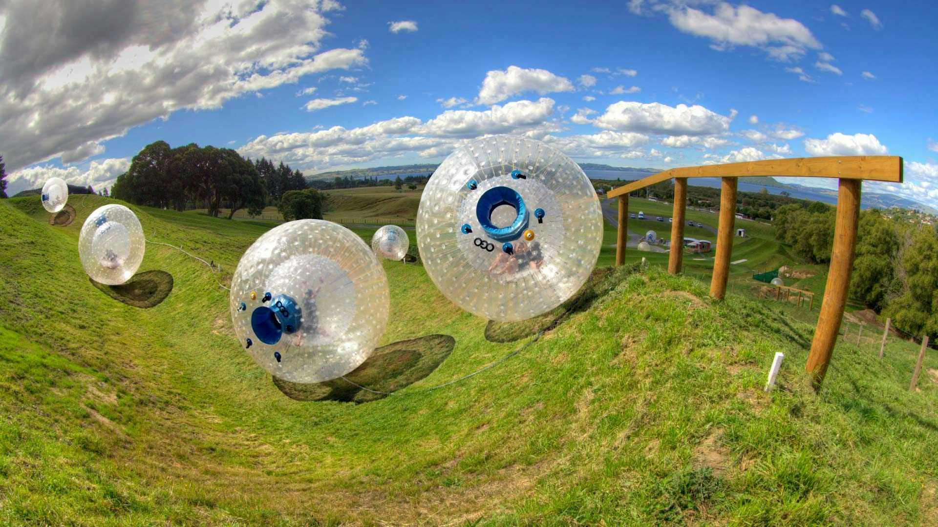 Zorbs rolling down a hill